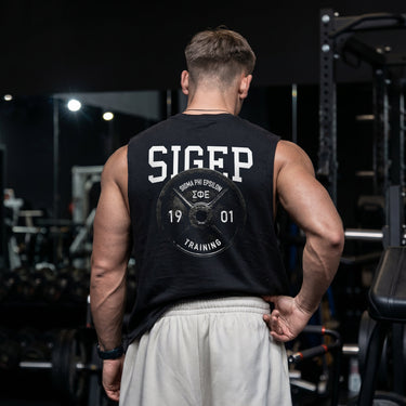 Man wearing a black cut off tank with premium grunge gym design