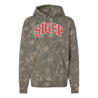 College-aged male wearing the fraternity Deadwood Camo Hoodie with red and white Sigma Phi Epsilon lettering, seated outdoors in a wooded setting.