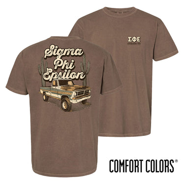 Comfort Colors Desert Highboy Tee shown front and back, featuring a small Sigma Phi Epsilon chest graphic and a large vintage truck desert design on the back.