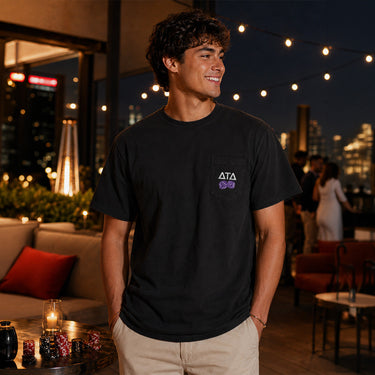 Model wearing the High Roller Tee from the front, featuring a chest pocket dice graphic on a black Comfort Colors tee.
