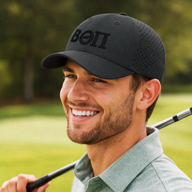 Black fraternity performance hat featuring 3D puff embroidered Greek letters and ventilated panels for a modern athletic look