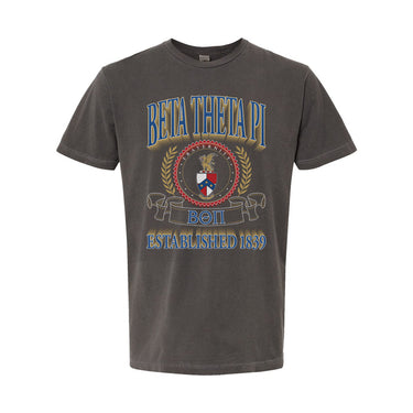 College-aged male wearing the fraternity Collegiate Crest Graphic Tee in charcoal grey, featuring vintage Beta Theta Pi crest artwork on campus.
