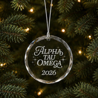 Limited Edition glass Christmas ornament with engraved design hanging on a decorated holiday tree