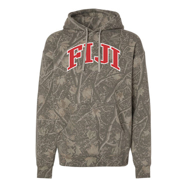 College-aged male wearing the fraternity Deadwood Camo Hoodie with red and white Phi Gamma Delta lettering, seated outdoors in a wooded setting.