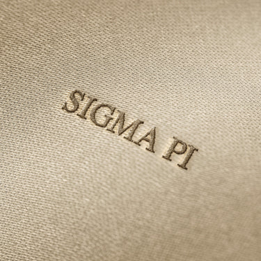 Soft beige fabric close-up showing a smooth, heavyweight knit texture with gentle folds and subtle draping.