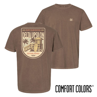 Brown Comfort Colors Surf Club Social T-shirt featuring a small front logo and a large surf club back graphic.
