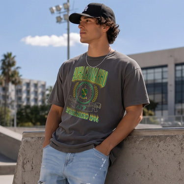 AGR Collegiate Crest Graphic Tee in charcoal grey featuring bold Alpha Gamma Rho lettering, fraternity crest, Greek letters, and established year design.