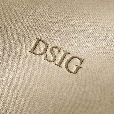 Soft beige fabric close-up showing a smooth, heavyweight knit texture with gentle folds and subtle draping.