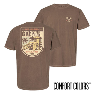 Brown Comfort Colors Surf Club Social T-shirt featuring a small front logo and a large surf club back graphic.
